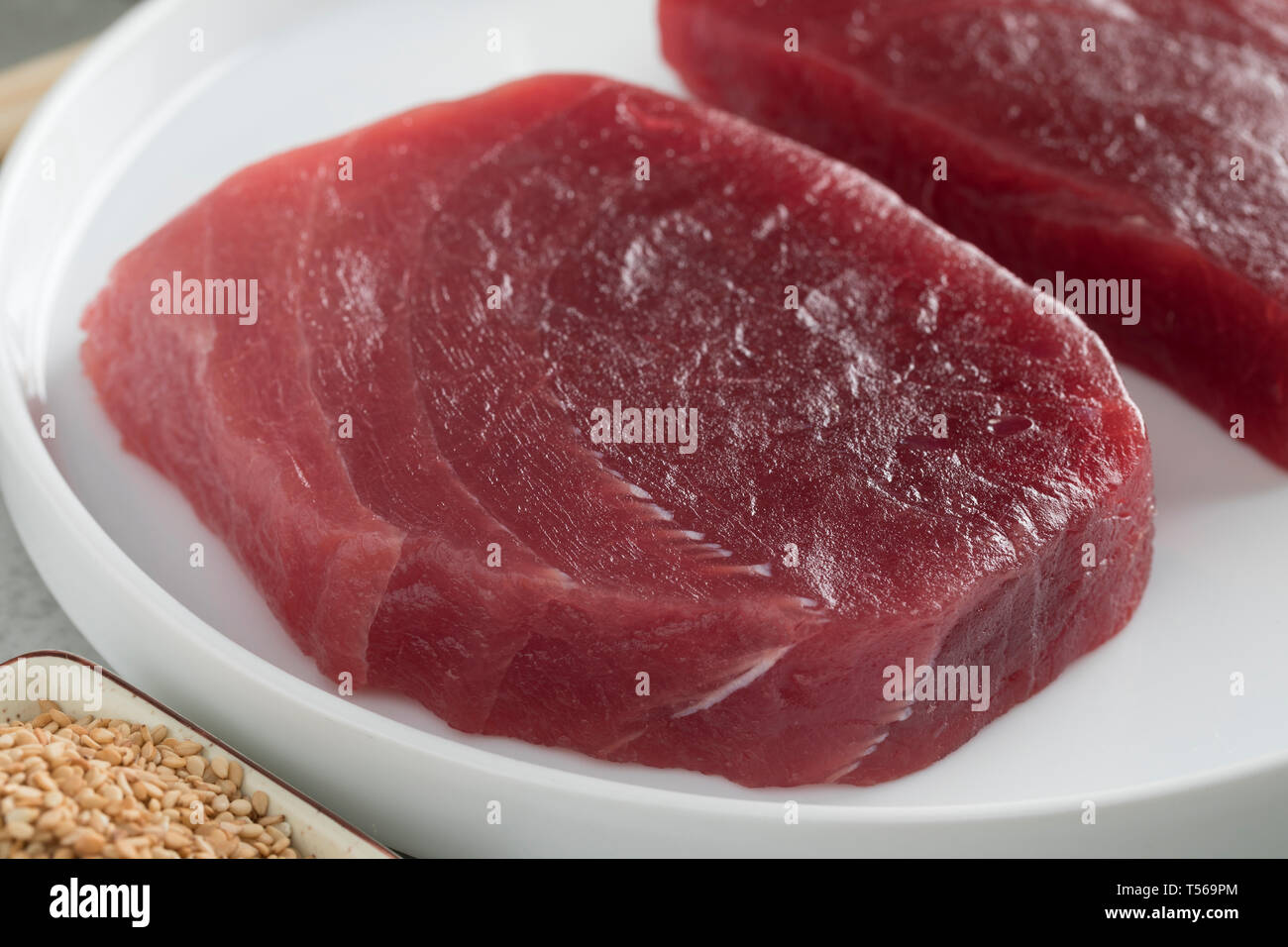 Dish with two fresh raw yellowfin tuna steaks close up Stock Photo Alamy
