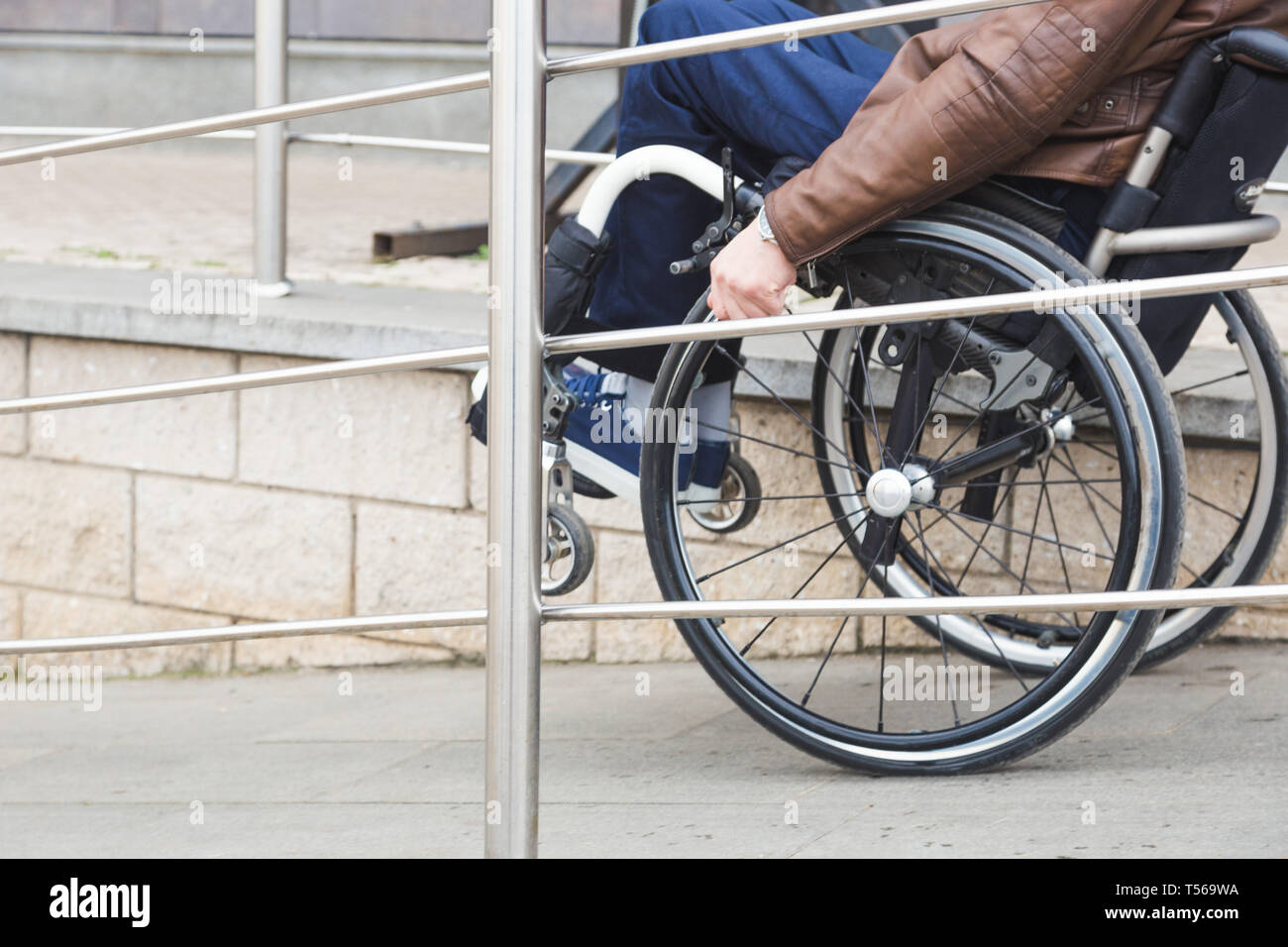 Man in a wheelchair use a wheelchair ramp Stock Photo - Alamy