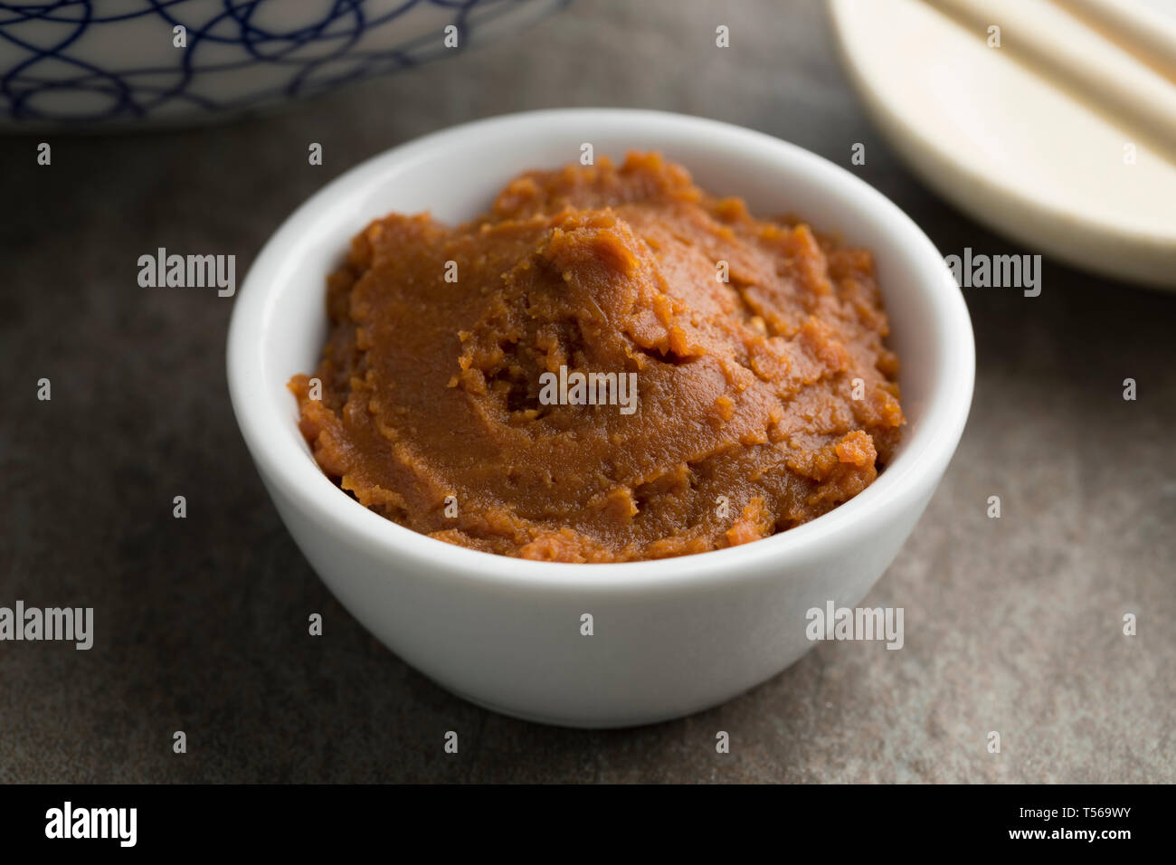 Bowl with red Japanese miso paste as an ingredient close up Stock Photo
