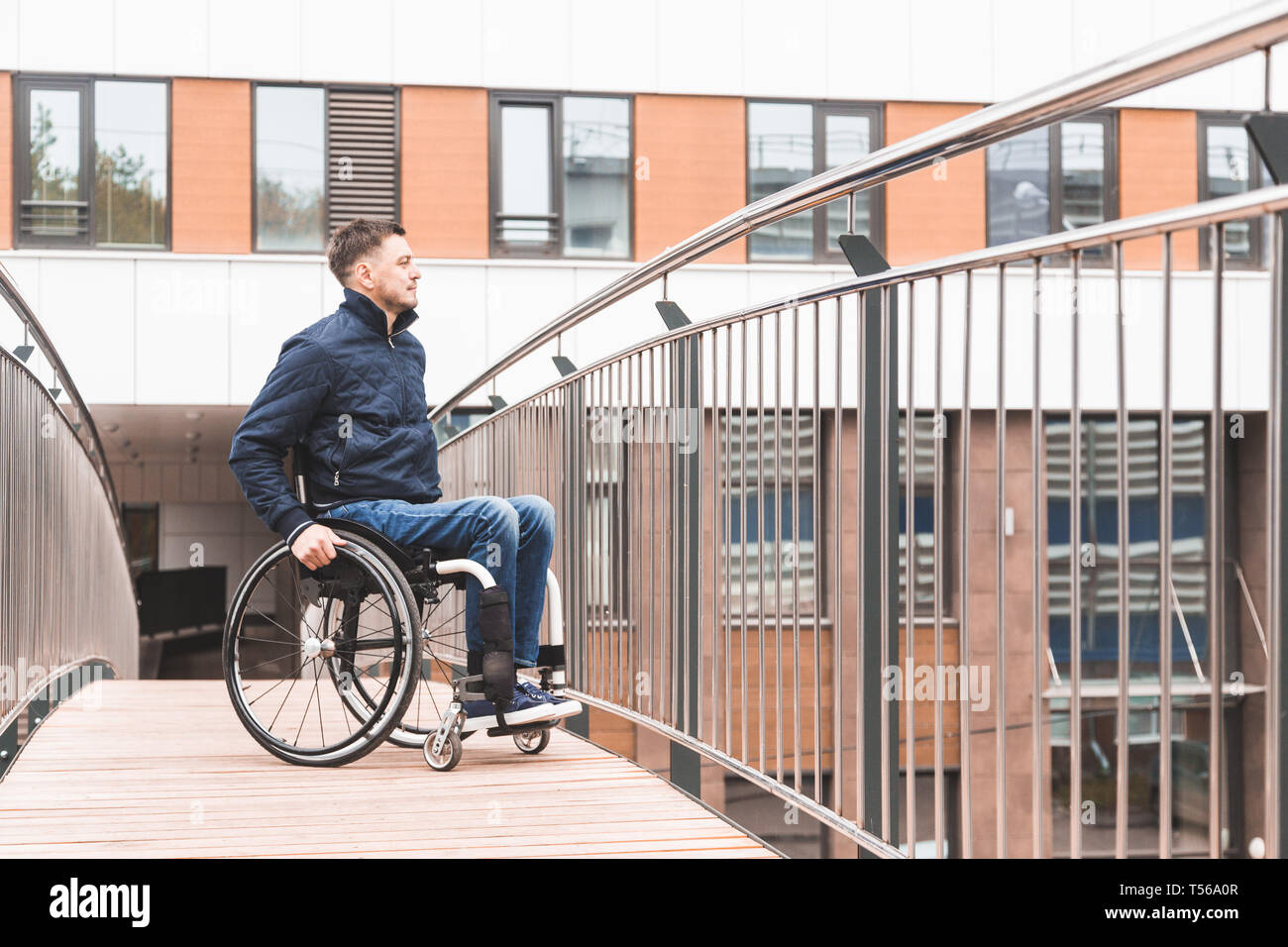 Man in a wheelchair use a wheelchair ramp Stock Photo - Alamy