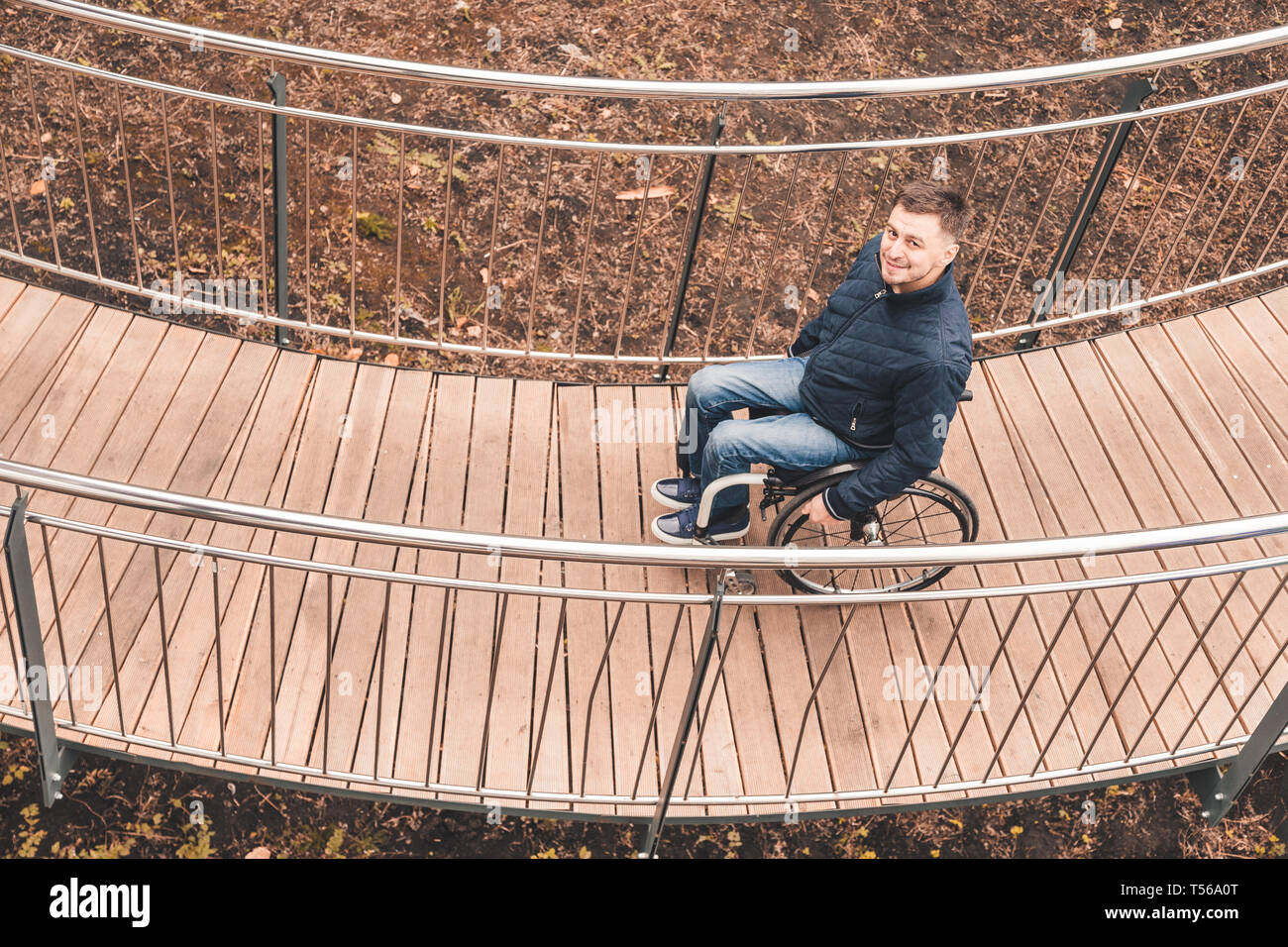Man in a wheelchair use a wheelchair ramp Stock Photo - Alamy