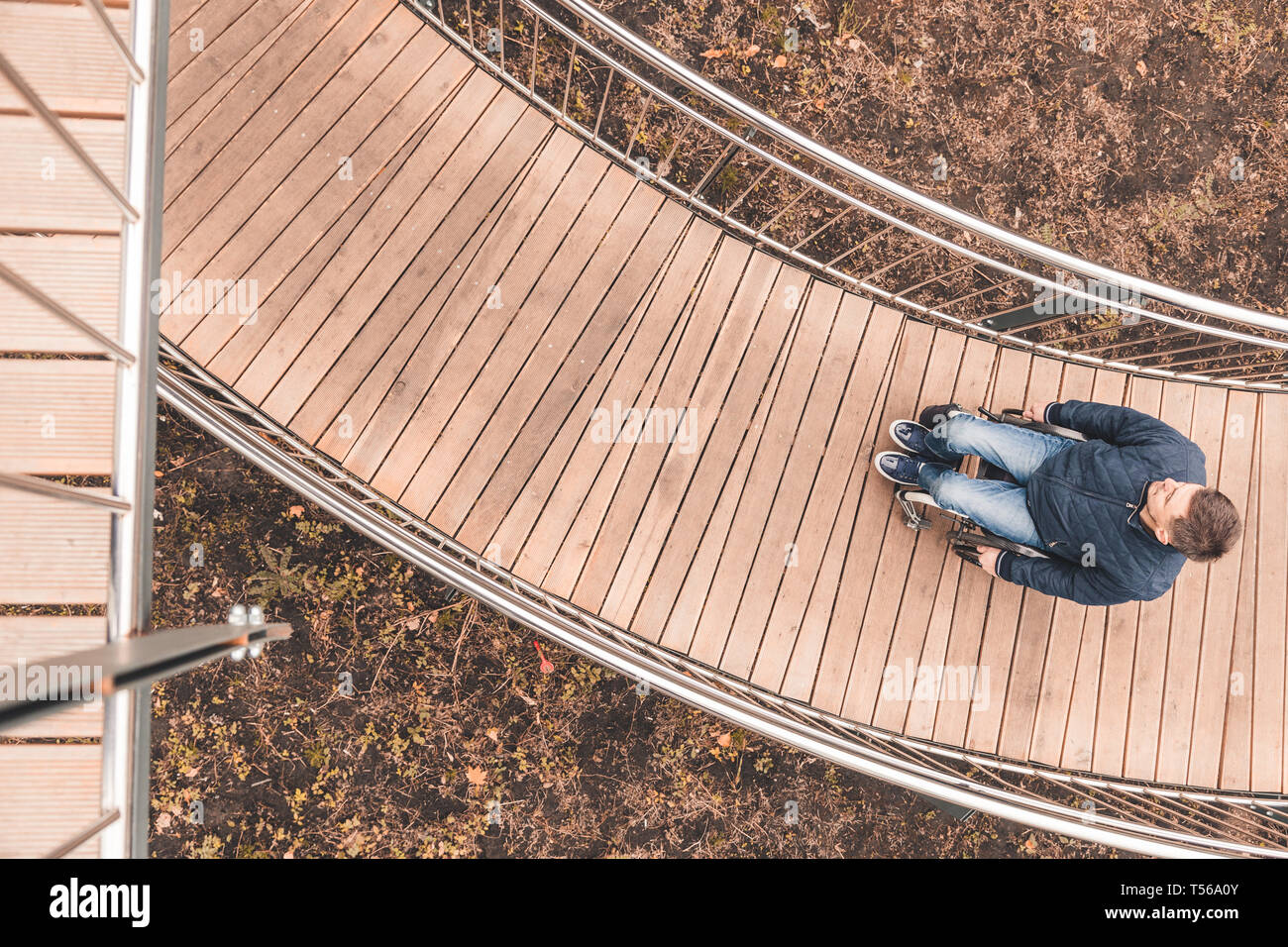 Man in a wheelchair use a wheelchair ramp Stock Photo - Alamy