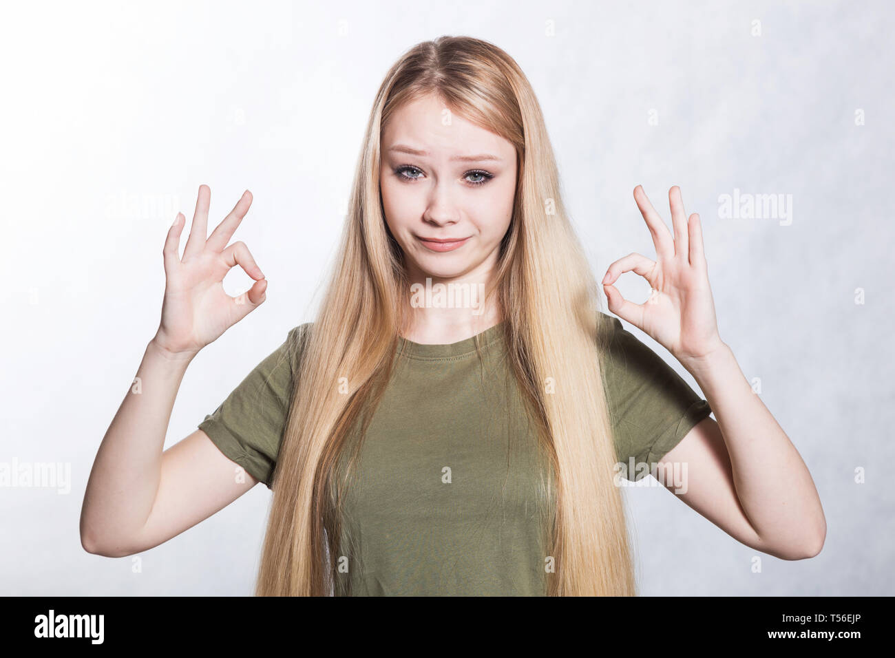 Young beautiful woman shows ok sign. Body language concept Stock Photo ...