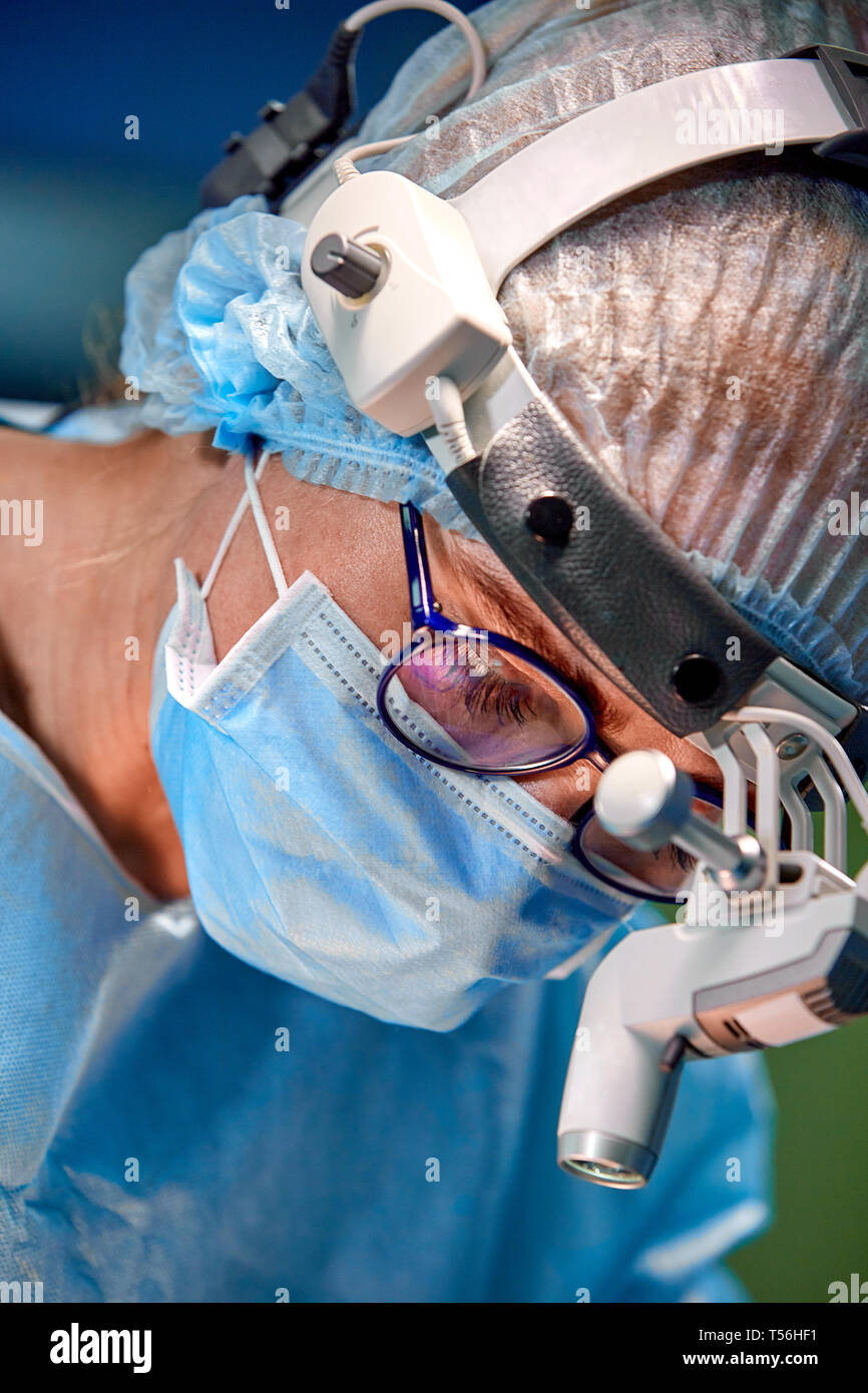 Close up portrait of female surgeon doctor wearing protective mask and ...