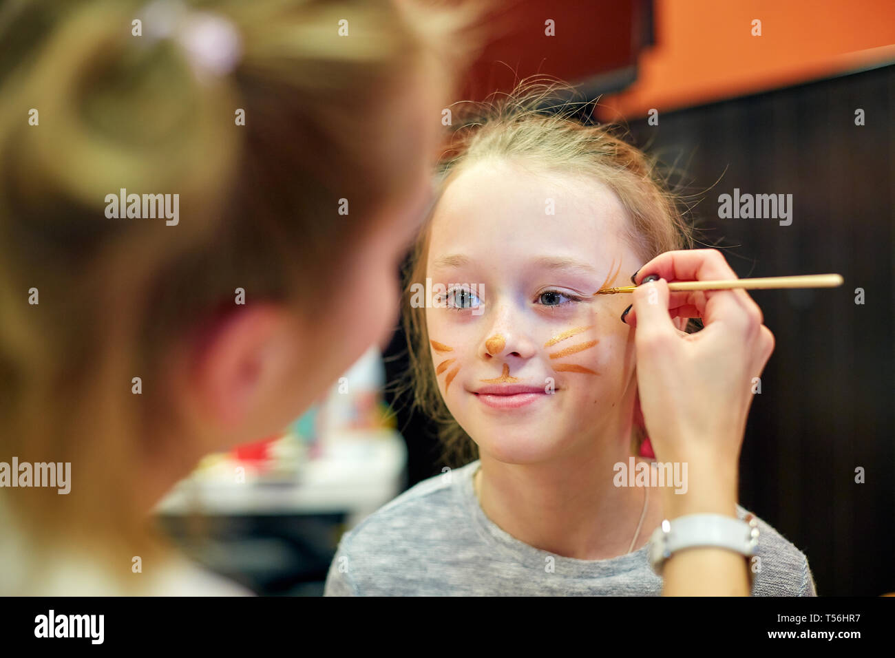 woman painting face of kid outdoors. baby face painting Stock Photo - Alamy