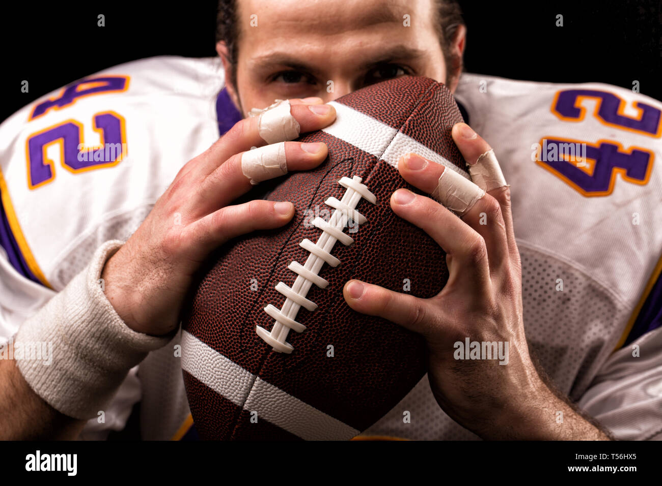 Close up portrait of American Football Player who gently kiss the ball  Stock Photo - Alamy