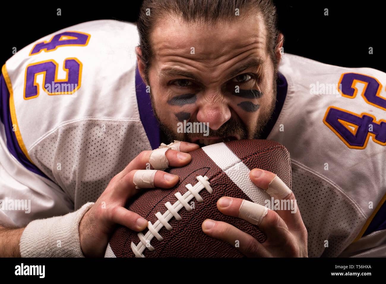 Close up portrait of aggressive American Football Player aggressive