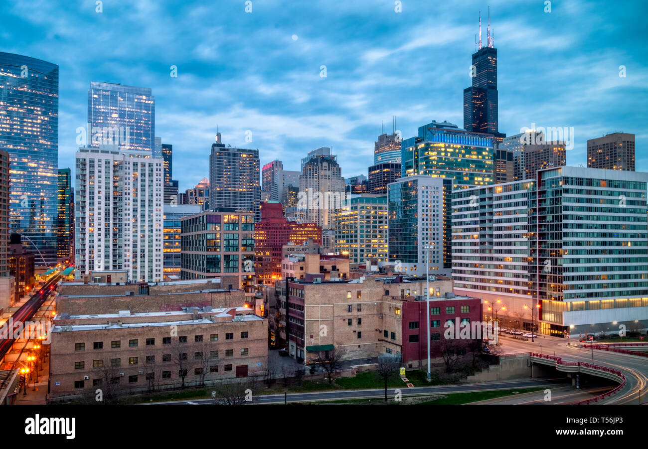 Blue Hour evening cityscape in West Loop neighborhood. Long exposure, nightscape architecture. Main street in Chicago, streets in Illinois. Stock Photo