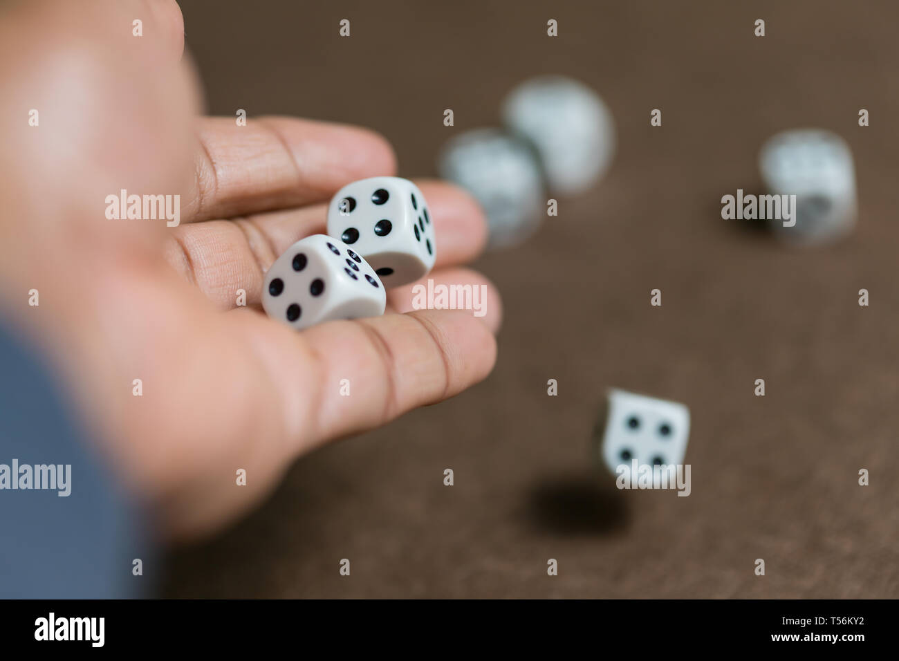 Man hand roll dice on board Stock Photo Alamy