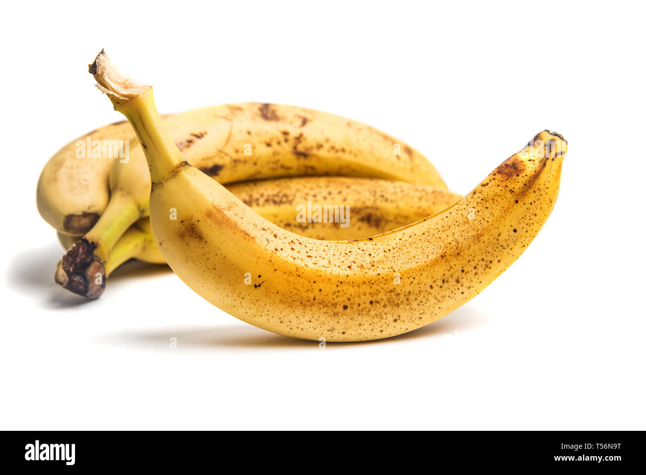 Ripe Bananas with dark spots isolated on white Stock Photo