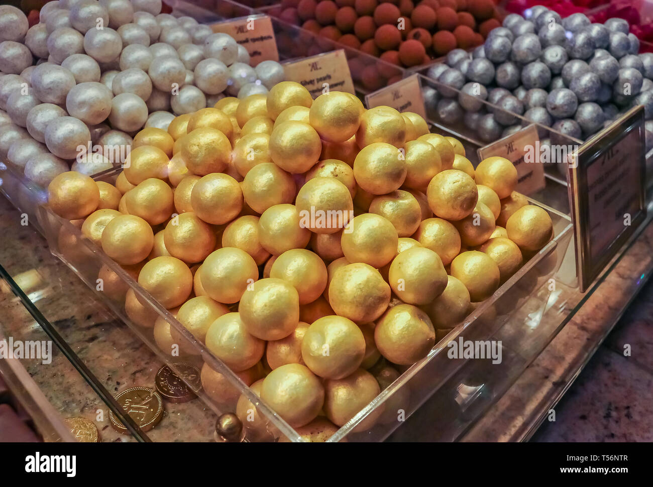 Saint Petersburg, Russia - October 05, 2015: Fancy gold and silver covered chocolate candy made in house on display at the famous grocery store Elisee Stock Photo