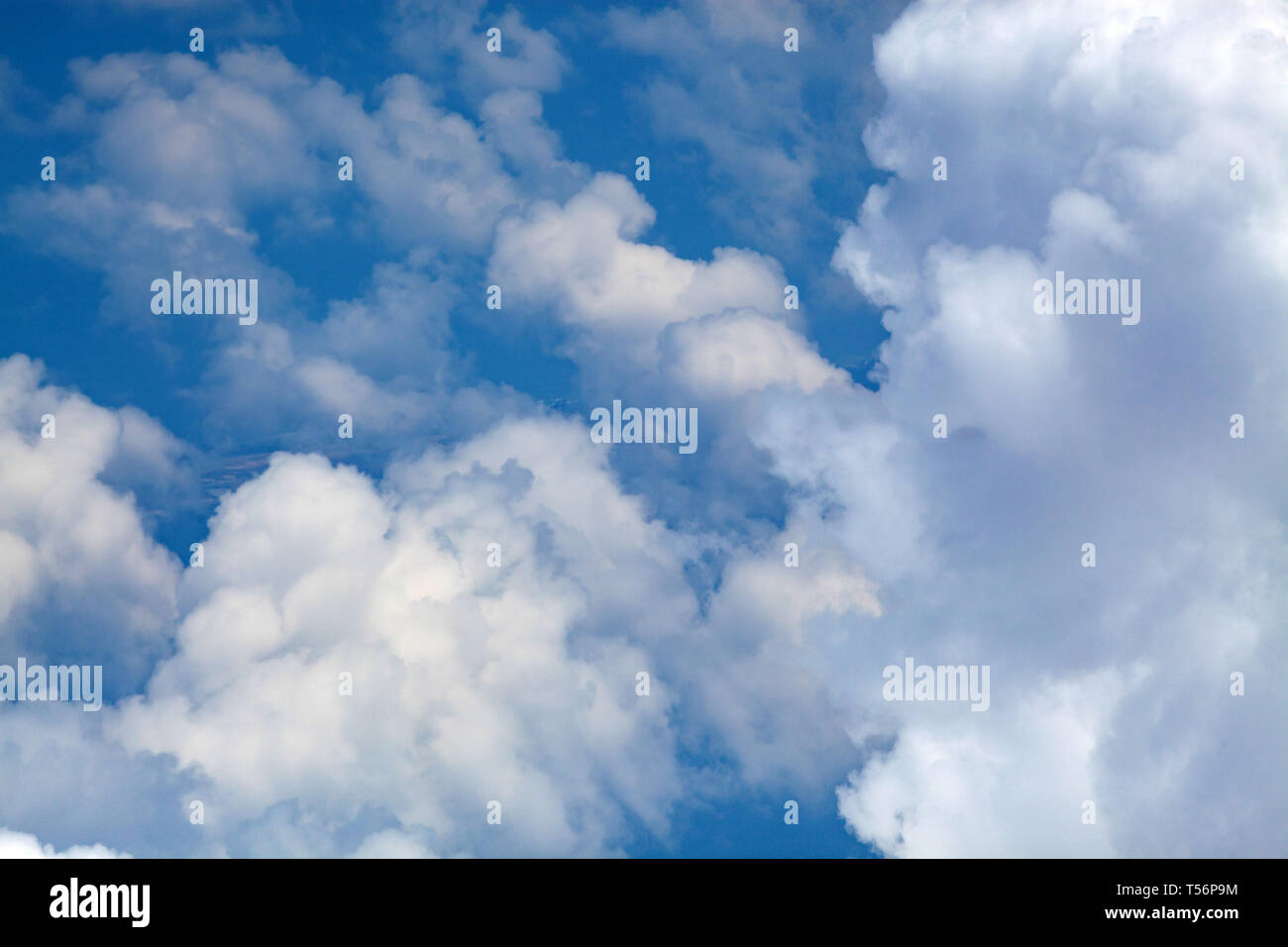 White fluffy clouds on blue hi-res stock photography and images - Alamy