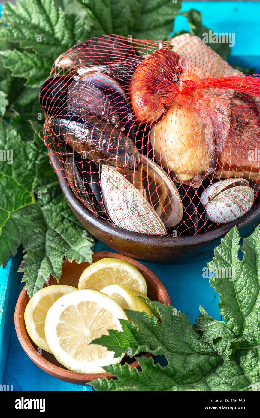 Famous traditional dish of the south of Chile and the Chiloe archipelago - Curanto al Hoyo, Kuranto. Different seafood, meat and potatoes milcao Stock Photo