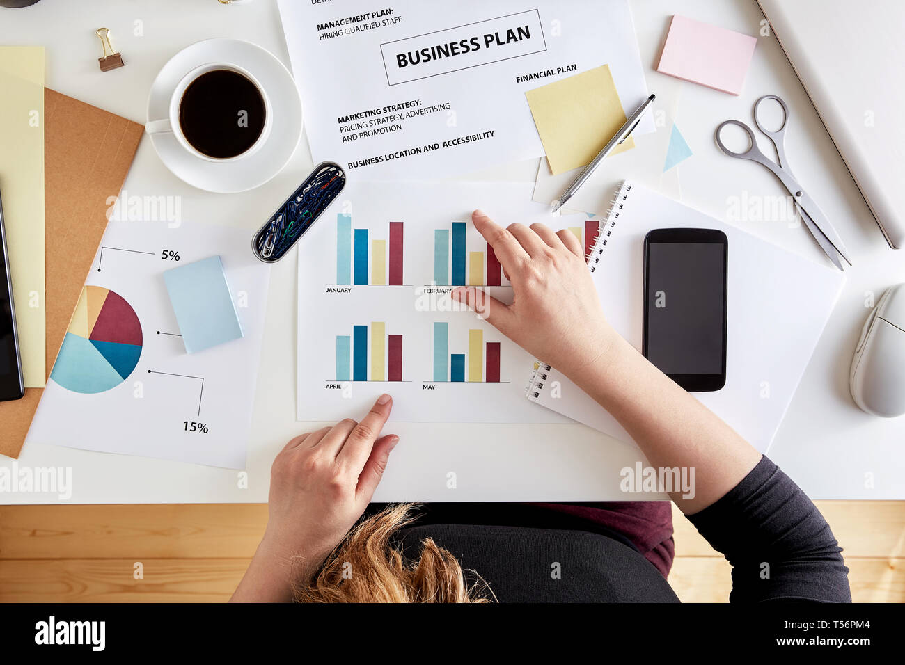 Overhead view of young woman entrepreneur planning business strategy. Desk of a modern businesswoman Stock Photo