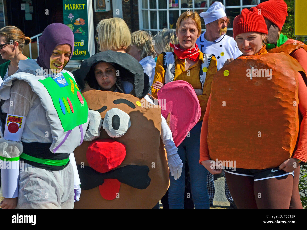 A cartoon characters team taking part in the annual Good Friday Marbles Competition in fancy dress in Battle Market Square, Battle, East Sussex, UK Stock Photo