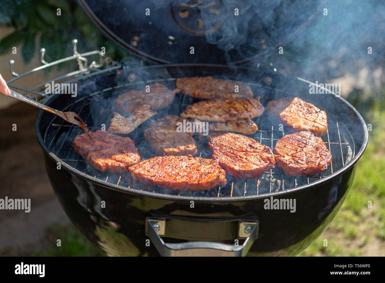 steaks cooking over flaming grill Stock Photo Alamy