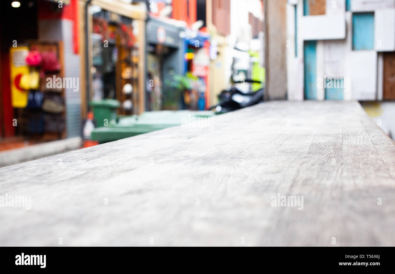 wooden table and blurred street scene in the background Stock Photo - Alamy