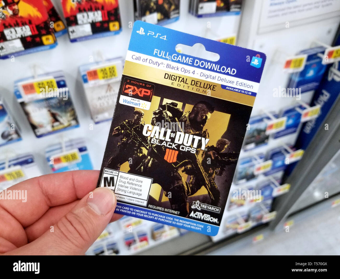 PLATTSBURGH, USA - JANUARY 21, 2019 : Gift card of Call of Duty Black Ops video game for PS4 in a hand of a buyer at Walmart store. Stock Photo