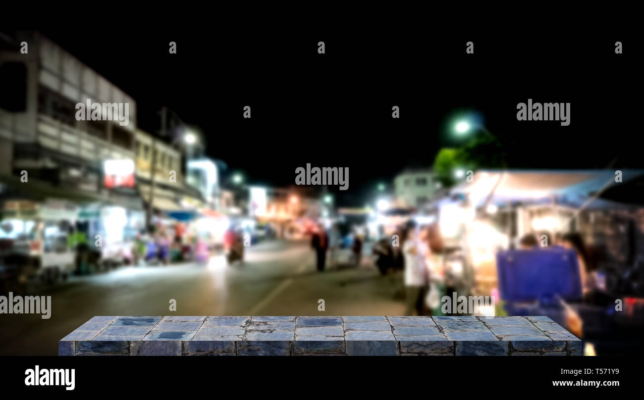 Empty stone shelf display with night market background Stock Photo