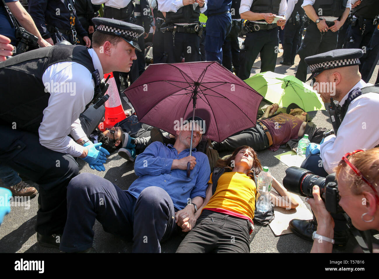 Environmental activists are seen lying on the ground at the Oxford Circus during the fifth day of the climate change protest by the Extinction Rebellion movement group. A large number of police presence around the pink yacht as they un-bond the activists who glued themselves and the police prepares to remove them from the site. According to the Met Police, over 1000 activists have been arrested since the demonstration started on 11 April 2019. Stock Photo