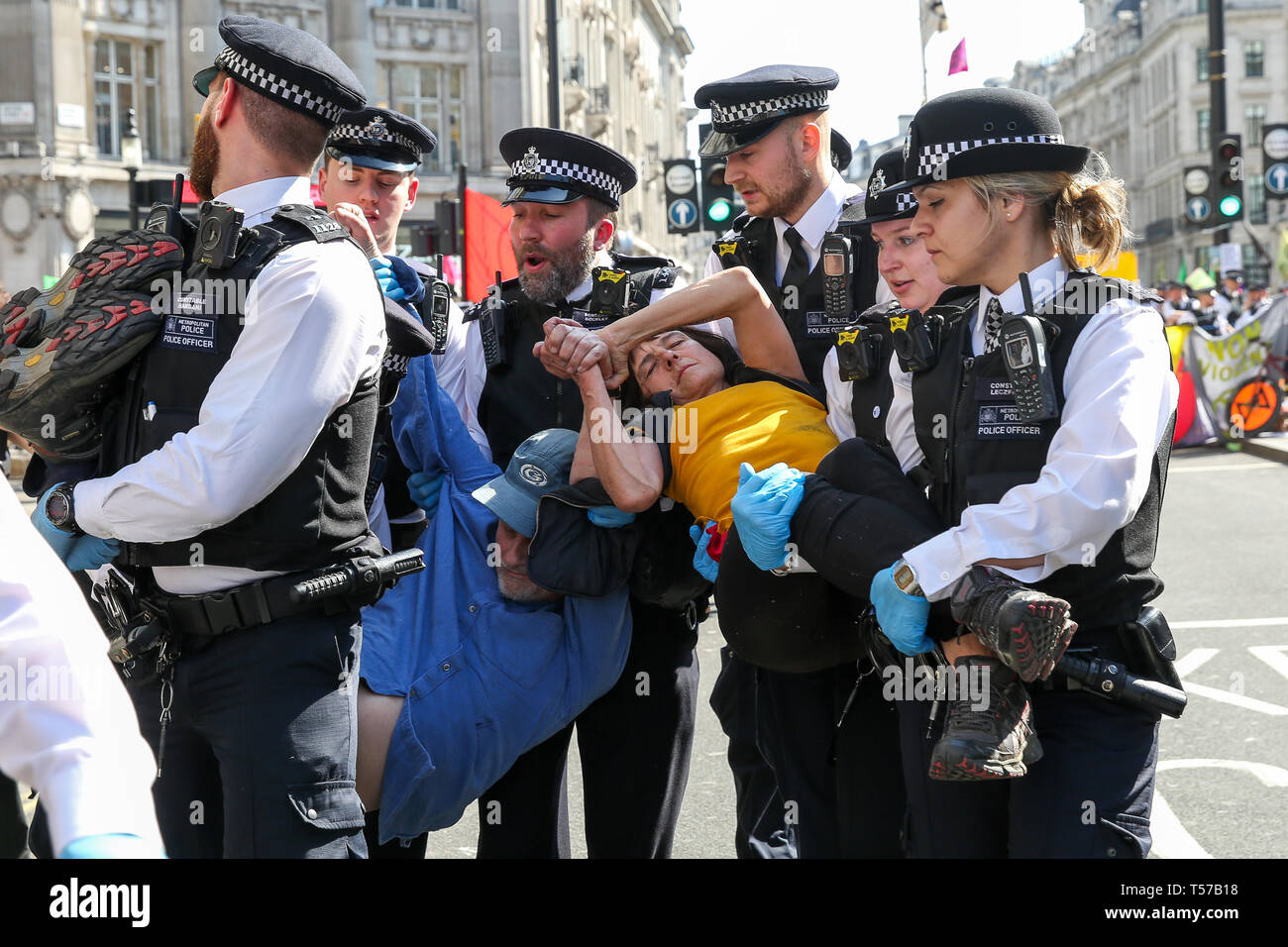 Environmental activists are seen being arrested by the police officers at the Oxford Circus during the fifth day of the climate change protest by the Extinction Rebellion movement group. A large number of police presence around the pink yacht as they un-bond the activists who glued themselves and the police prepares to remove them from the site. According to the Met Police, over 1000 activists have been arrested since the demonstration started on 11 April 2019. Stock Photo
