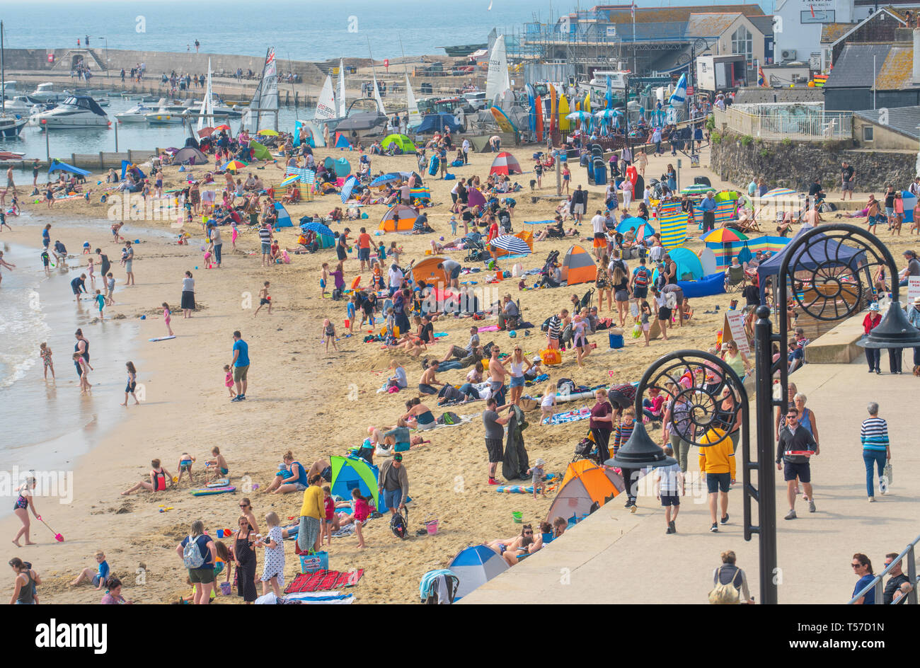 Lyme Regis, Dorset, UK. 22nd April 2019. UK Weather: Holiday makers and beach goers secure a spot early on the pretty beach at the seaside resort of Lyme Regis to enjoy a day of hot and hazy sunshine on the Bank Holiday.  Visitors have enjoyed record breaking heat over the Easter weekend with temperatures set to soar even further today. Credit: Celia McMahon/Alamy Live News. Stock Photo