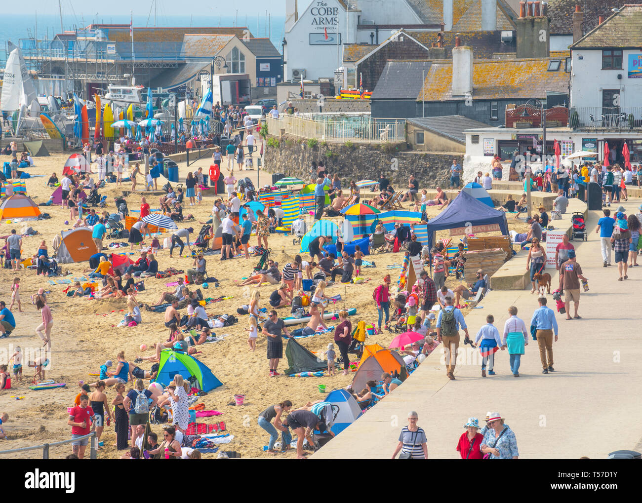 Lyme Regis, Dorset, UK. 22nd April 2019. UK Weather: Holiday makers and beach goers secure a spot early on the pretty beach at the seaside resort of Lyme Regis to enjoy a day of hot and hazy sunshine on the Bank Holiday.  Visitors have enjoyed record breaking heat over the Easter weekend with temperatures set to soar even further today. Credit: Celia McMahon/Alamy Live News. Stock Photo