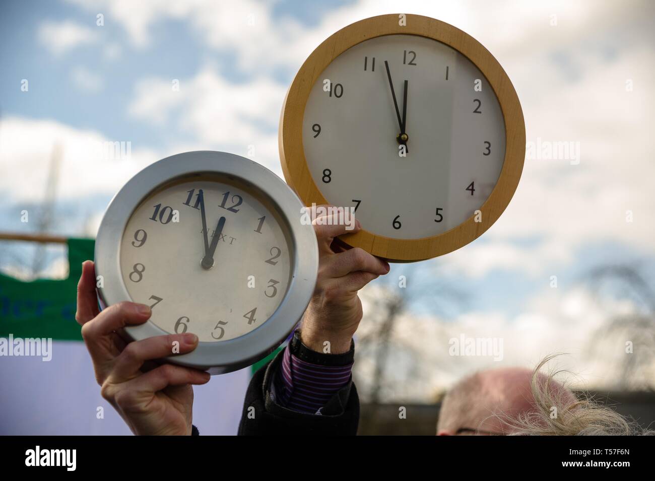 Edinburgh, Lothian, UK. 2nd Apr, 2019. Protesters seen holding up clocks during the demonstration.Environmental campaigners staged a protest outside of the Scottish Parliament to call on Members of Scottish Parliament for greater urgency in tackling climate change. The theme of the protest was ''Running out of Time'', Members of Scottish Parliament were debating on a new law that would shape the climate plans for the coming decades. Credit: Stewart Kirby/SOPA Images/ZUMA Wire/Alamy Live News Stock Photo