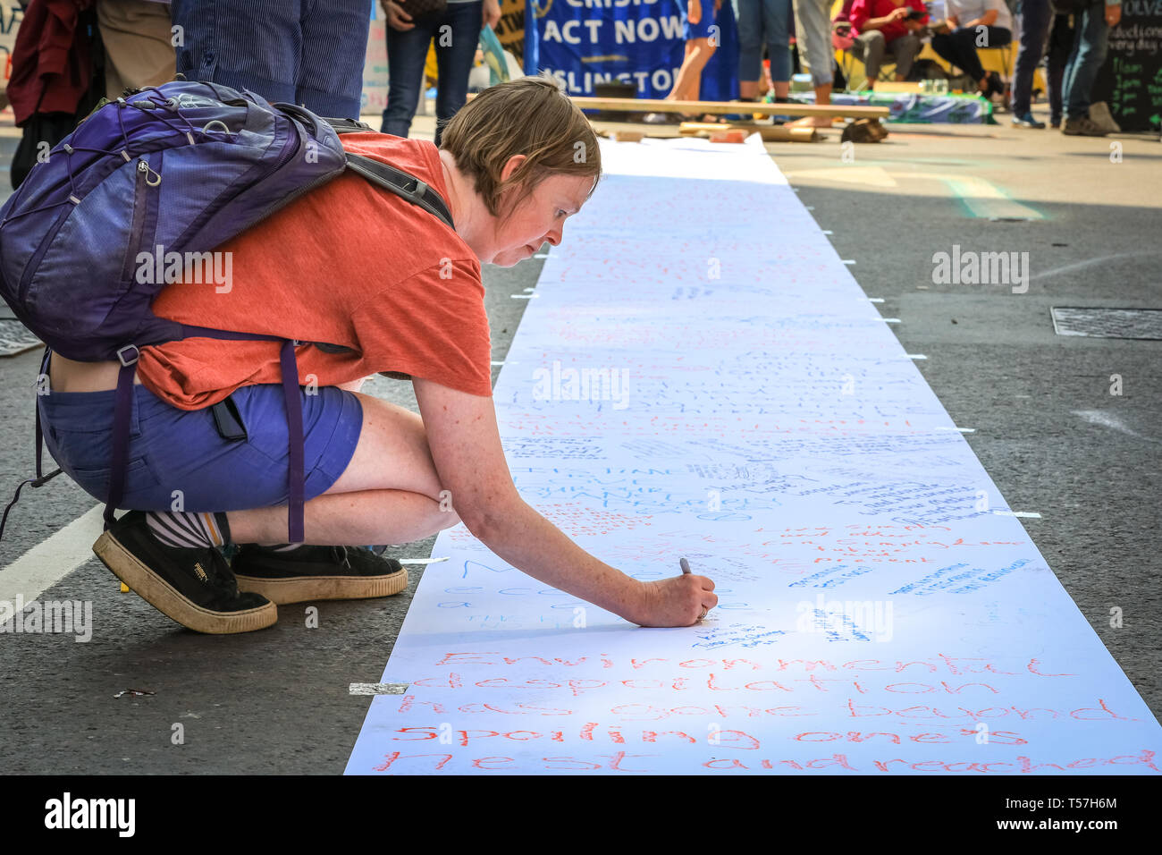 Marble Arch, London, UK. 22nd Apr, 2019. People write down messages about climate change. Activists once again protest largely peacefully in bright sunshine at Marble Arch. Campaigners were back at Marble Arch - the only Met-sanctioned protest space - on Monday, as activists met to plan the week ahead. The Marbe Arch site includes a large tented area for protesters to sleep and rest. Credit: Imageplotter/Alamy Live News Stock Photo