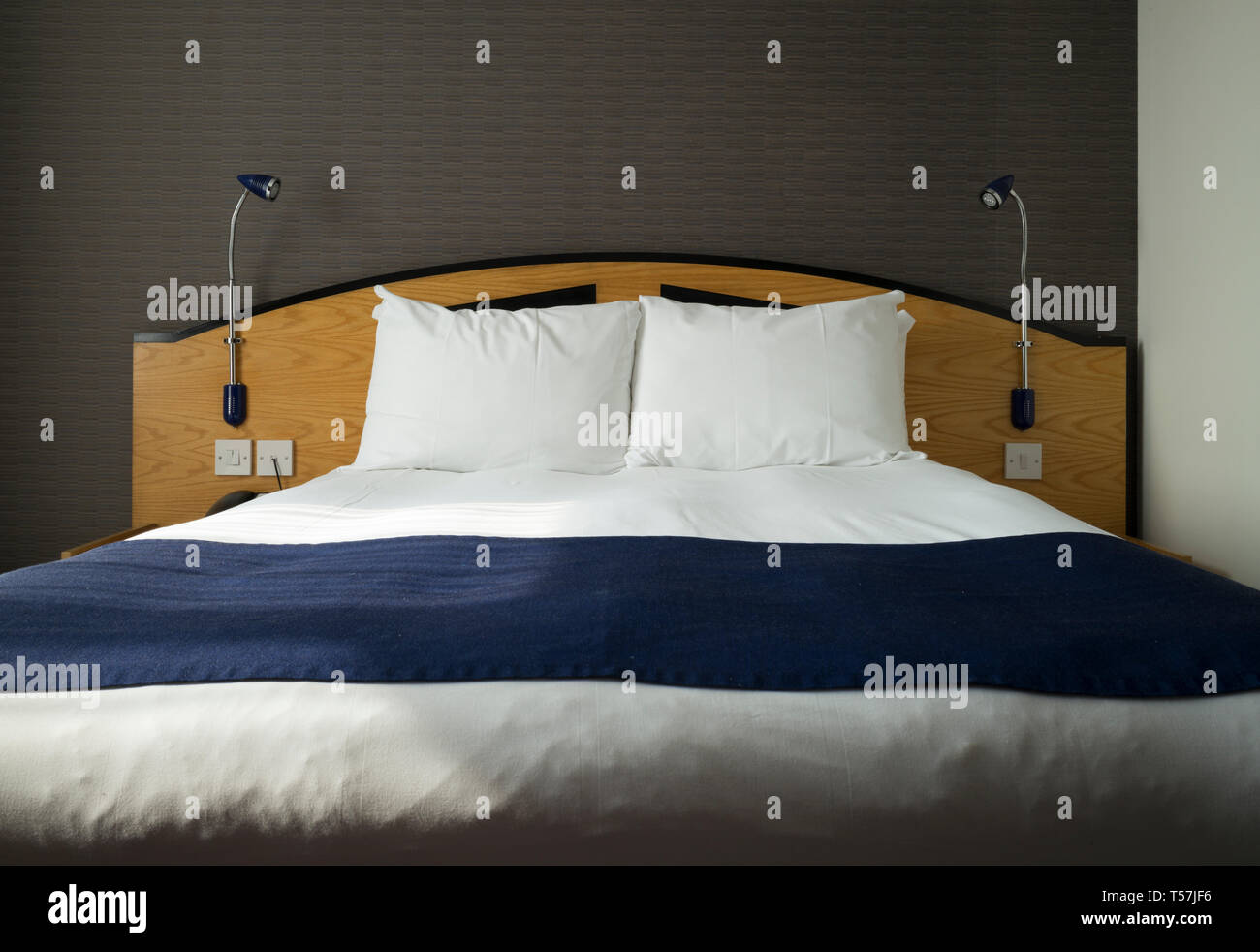 Freshly Made Double Bed With Pillows Sheets And Bedding In