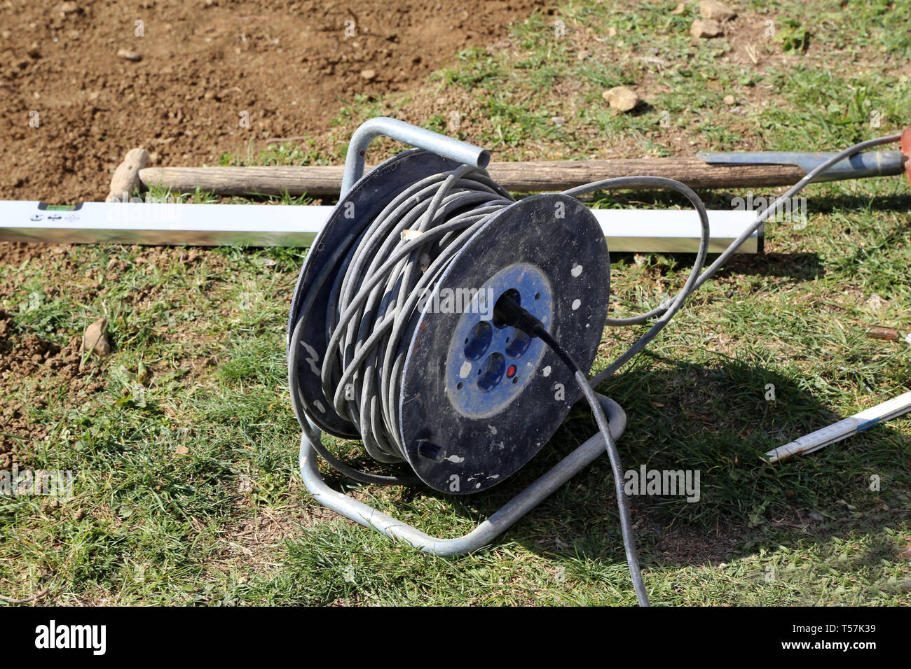 Electrical power extension cable reel at the repairs site Stock Photo