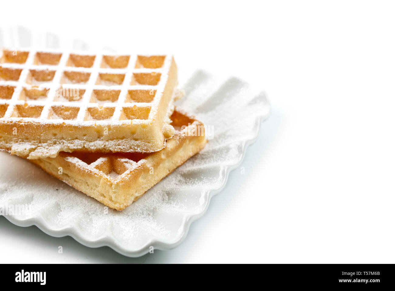 Belgium waffers with sugar powder on ceramic plate isolated on white ...