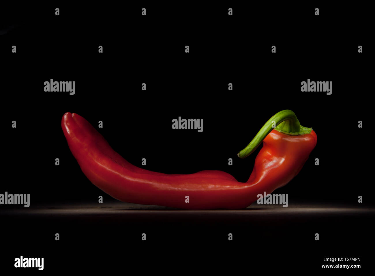 Red hot Chilli with black ground Stock Photo