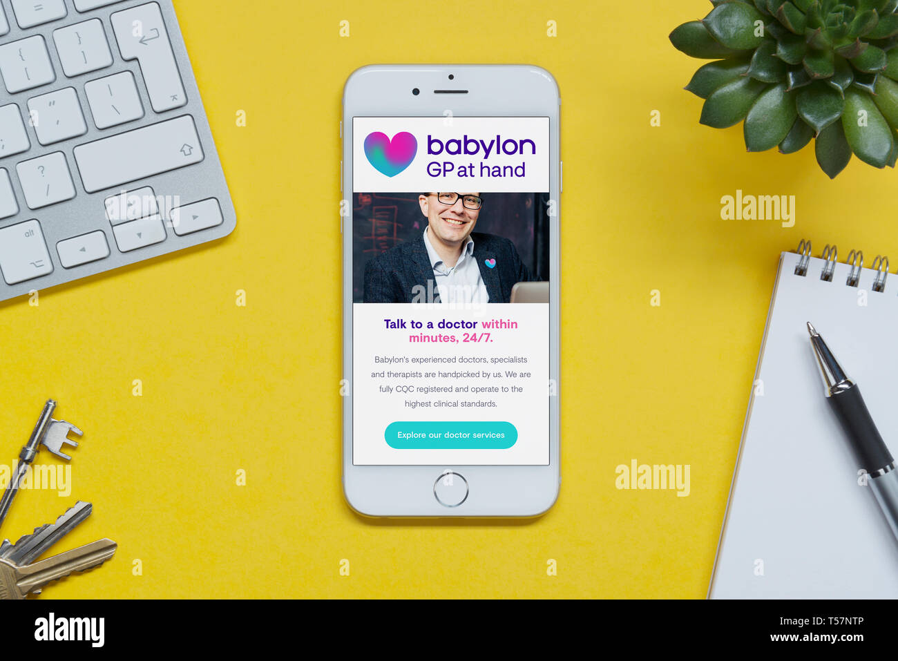 An iPhone showing the Babylon GP at Hand website rests on a yellow