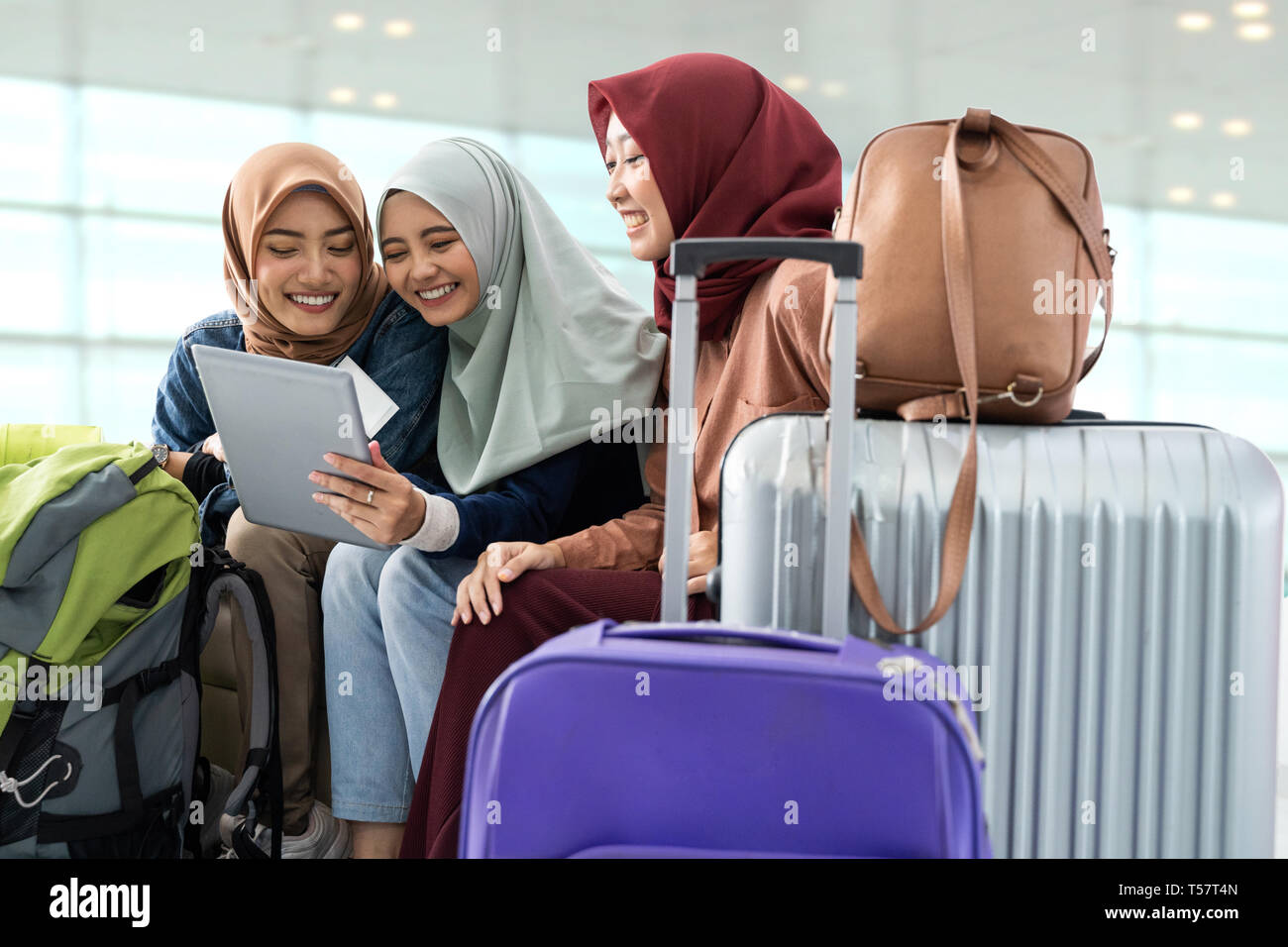 muslim asian woman friend sitting in airport terminal Stock Photo - Alamy