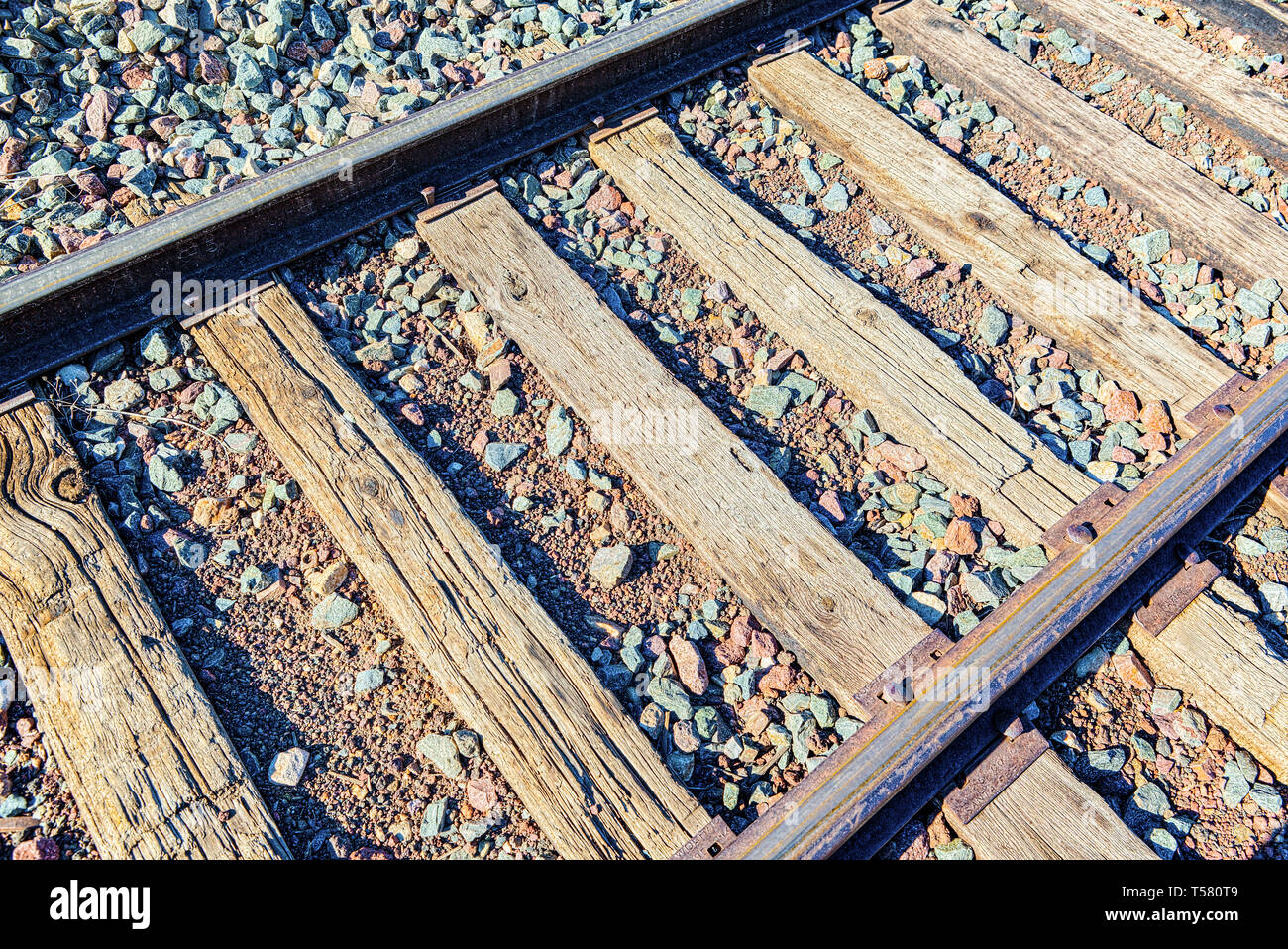 Old railway sleepers and rails in an American town. USA. Stock Photo