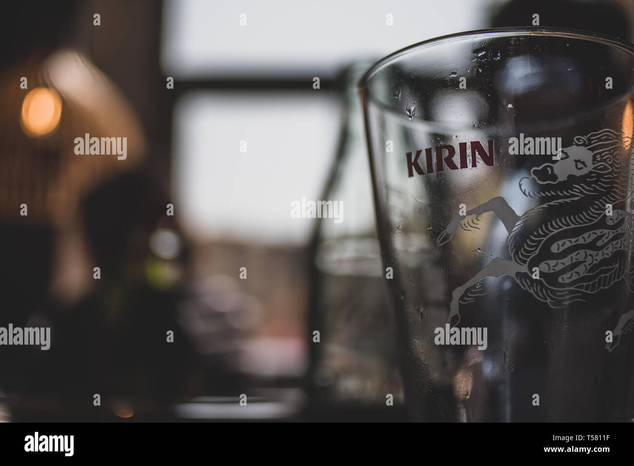 Craft beer Kirin - empty glass at a cafe table. Stock Photo