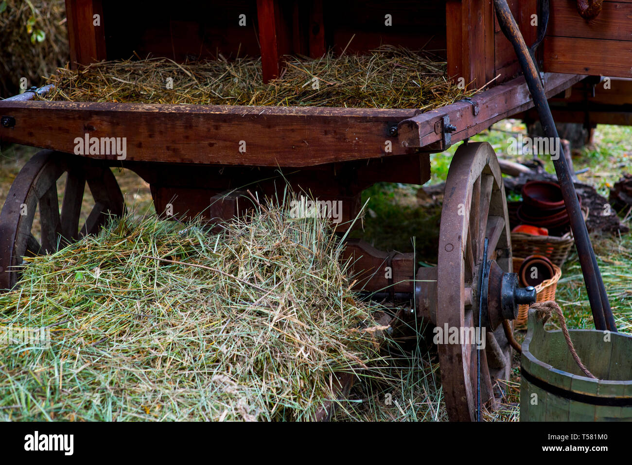 wooden cart with dried hay in front of an old farm Stock Photo Alamy
