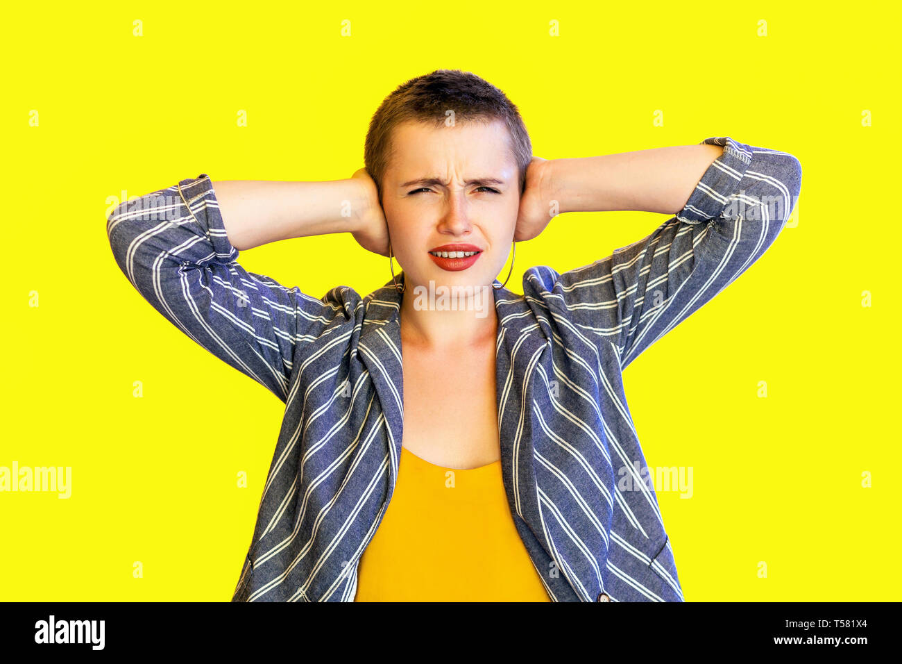 Portrait Of Unhappy Young Short Hair Beautiful Woman In Yellow