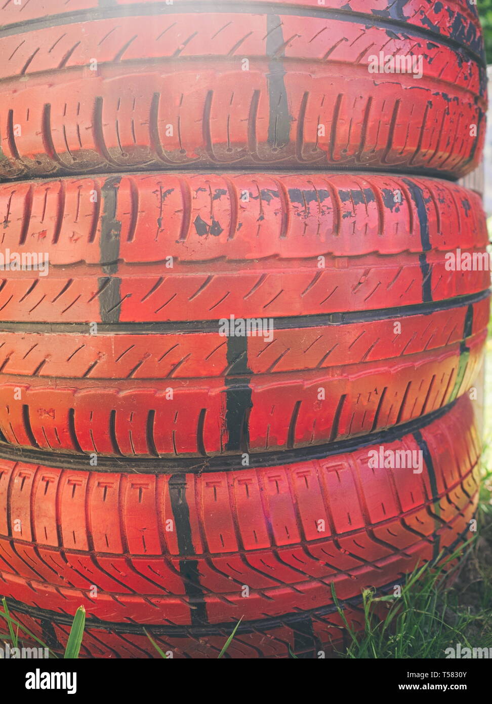 Red Painted Car Tires in the Garden Closeup Stock Photo