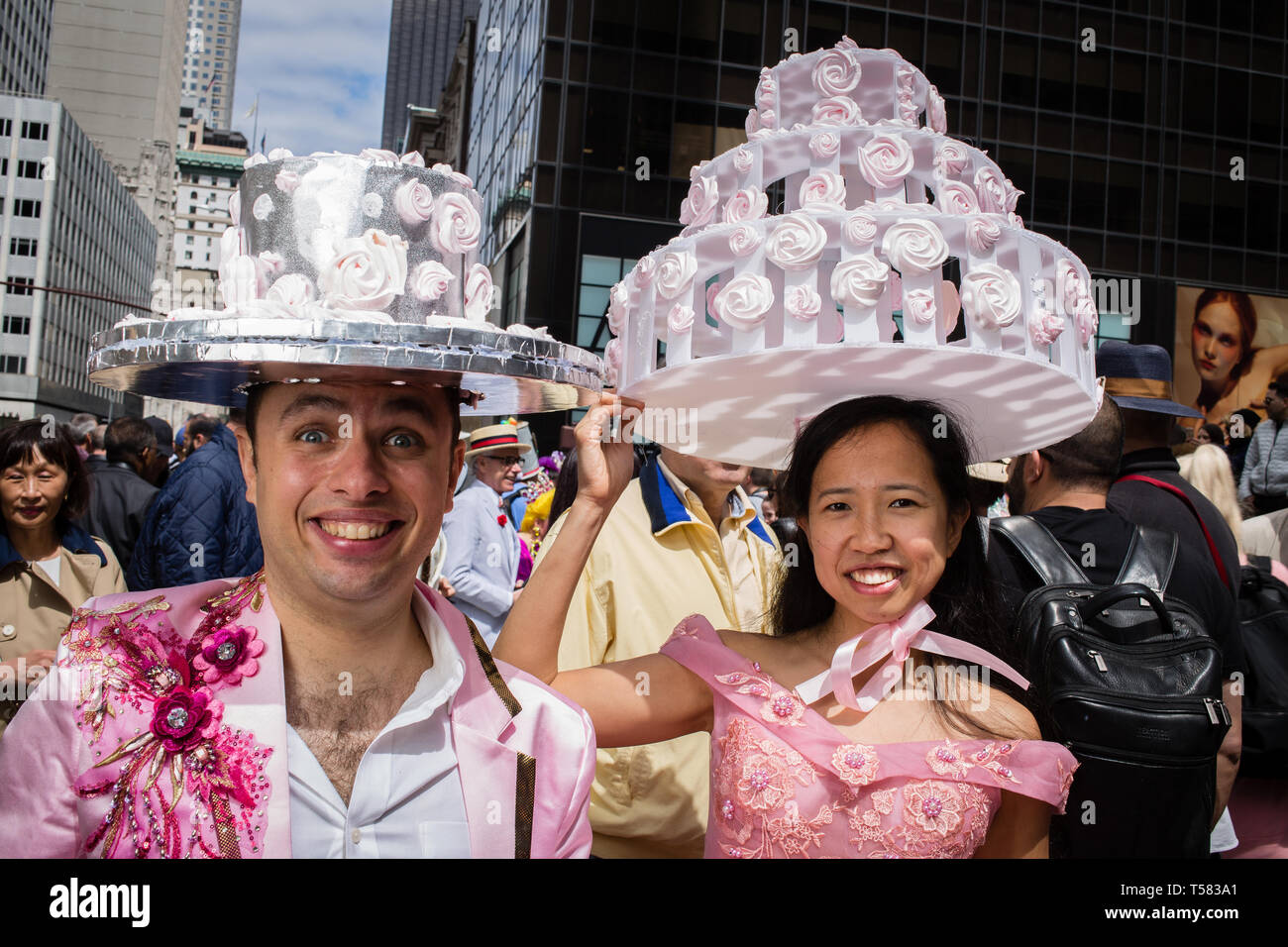 New York, NY - 21 April 2019. A  couple with ornate wedding-cake hats at the Easter Bonnet Parade and Festival on New York's Fifth Avenue. Stock Photo