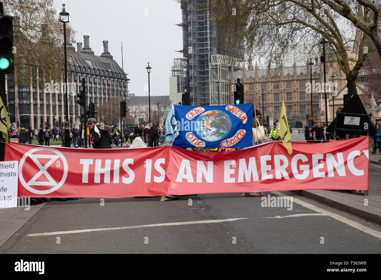 Extinction Rebellion protesters seen behind a large and wide banner during a protest in London. Stock Photo
