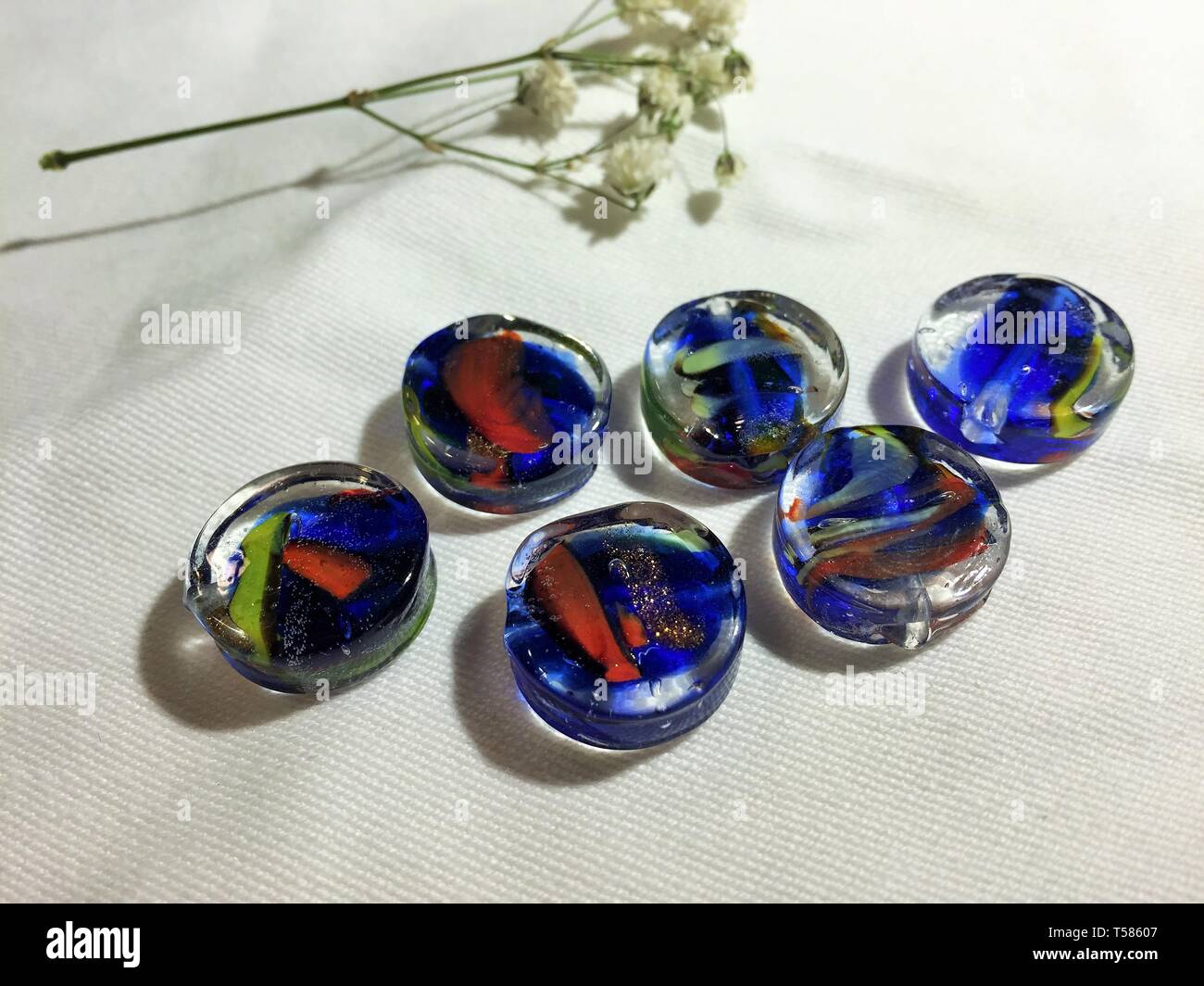 Blue, yellow, and clear glass beads Stock Photo