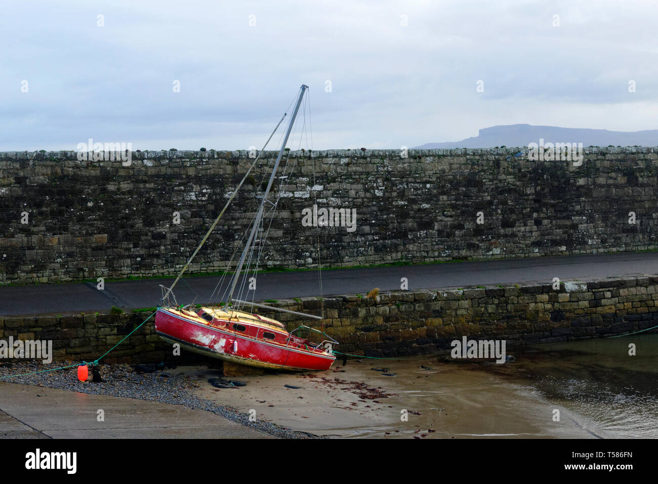 Old wooden boat beached at low tide, County Mayo, Republic of Ireland. Stock Photo