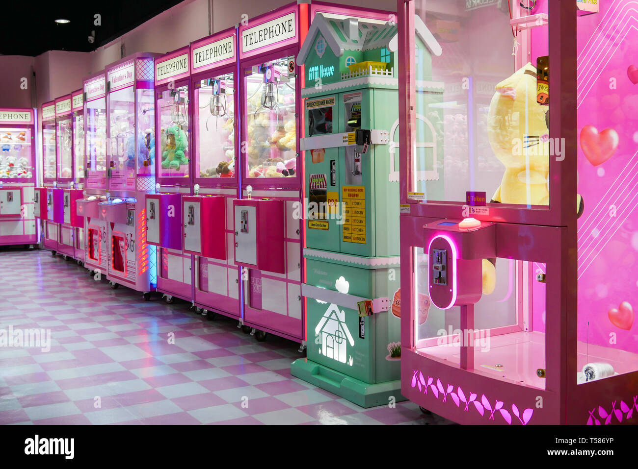 Kuala Lumpur,Malaysia - April 13,2019 : Colorful arcade game toy claw crane machine where people can win toys and other prizes which is located in the Stock Photo