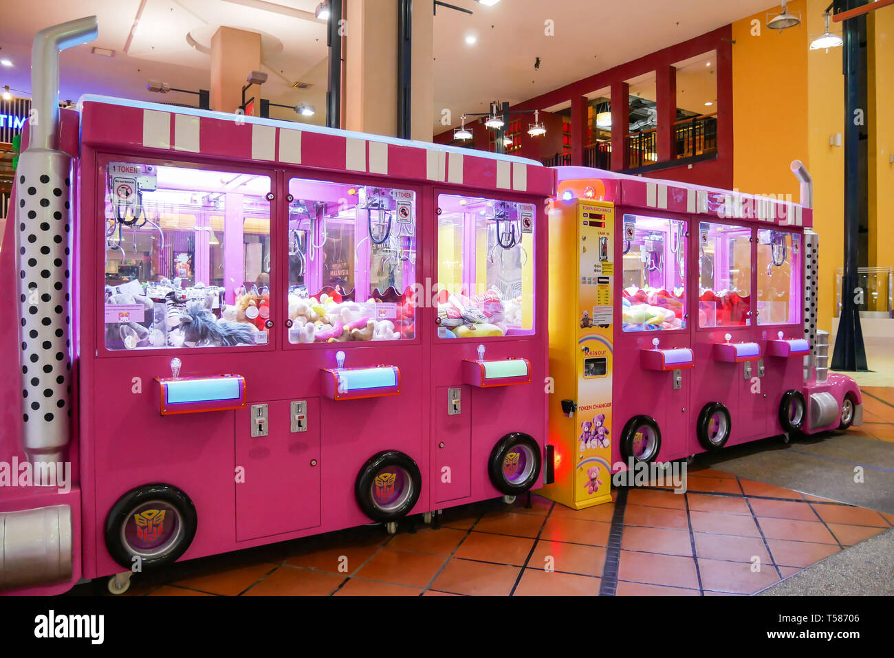 Kuala Lumpur,Malaysia - April 13,2019 : Colorful arcade game toy claw crane machine where people can win toys and other prizes which is located in the Stock Photo