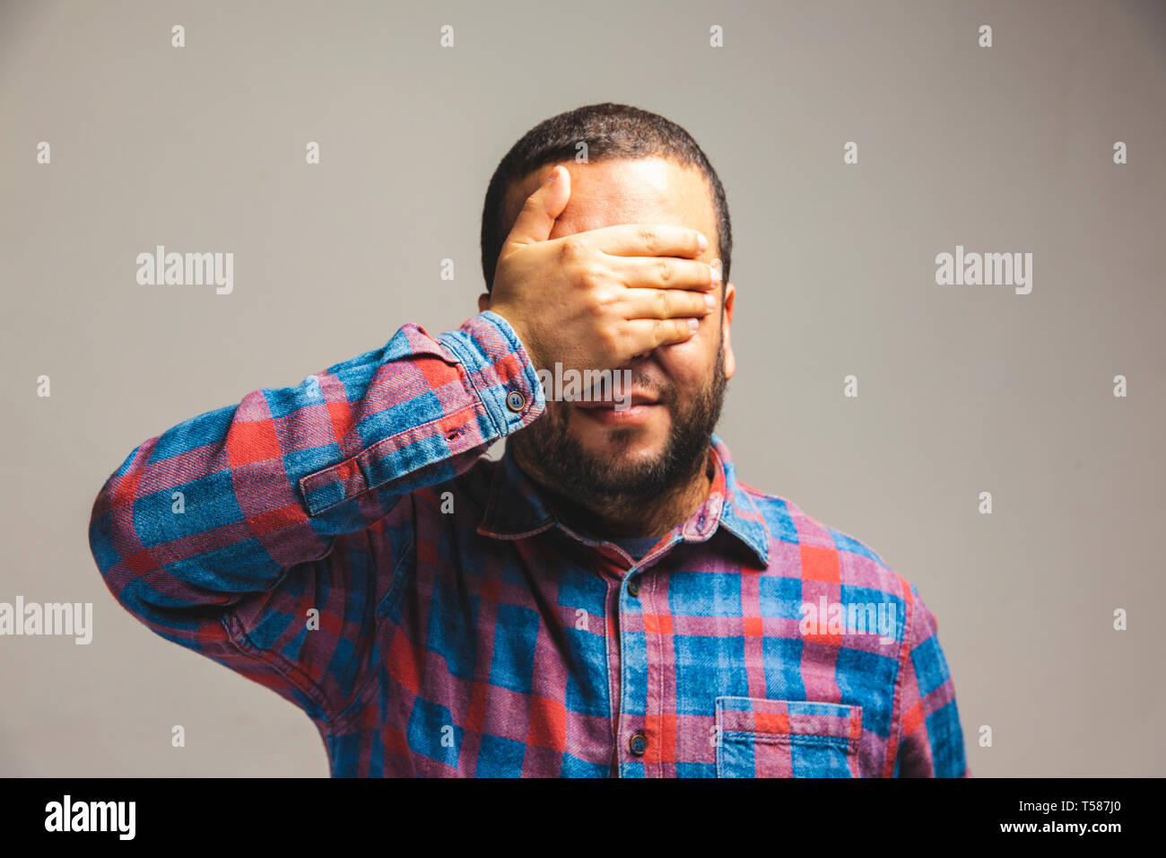 close up view of a man covering his eyes with hand Stock Photo - Alamy