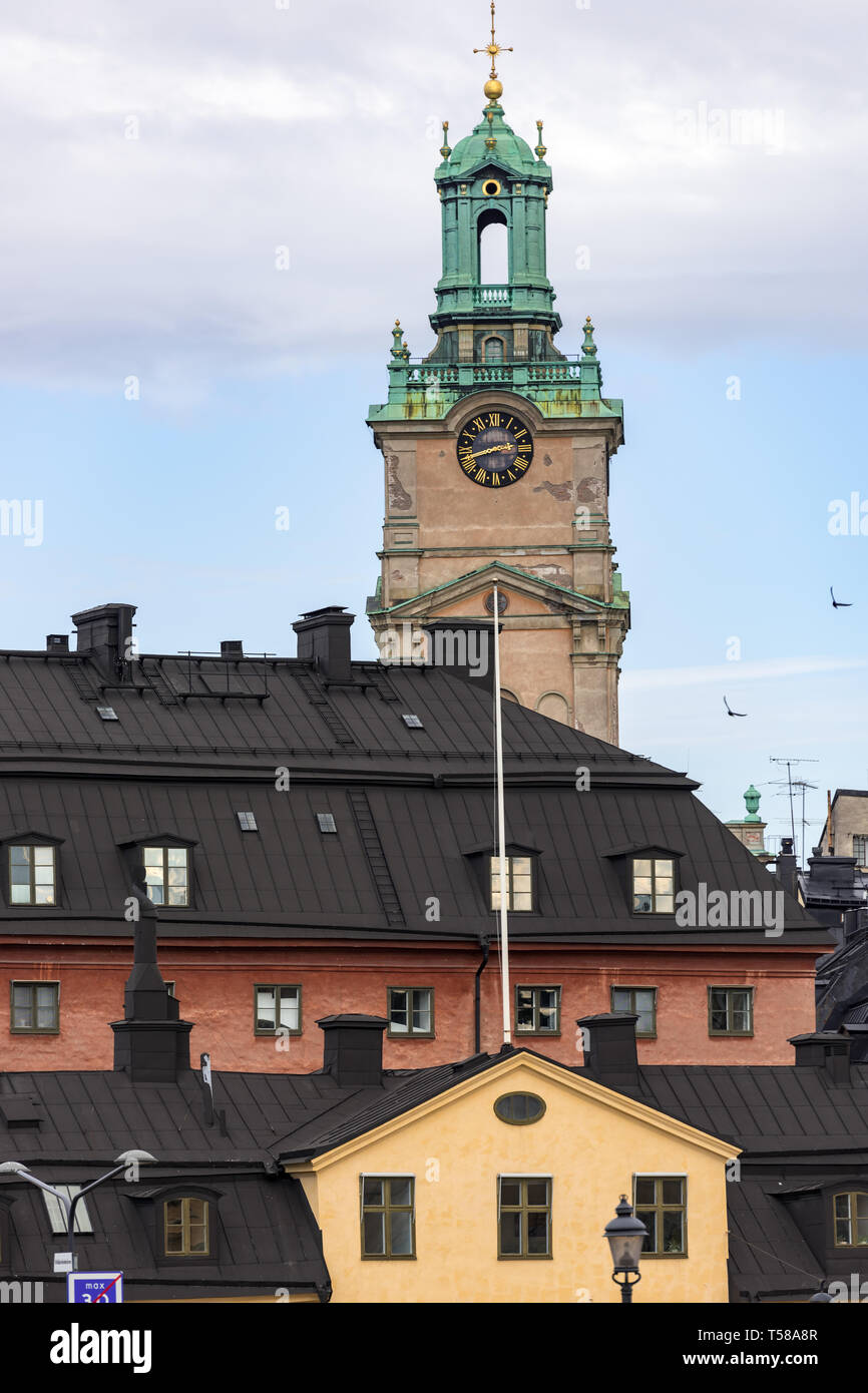 The ornate tower and lantern of Storkyrkan towers over the colourful buildings of Gamla Stan in Stockholm Stock Photo