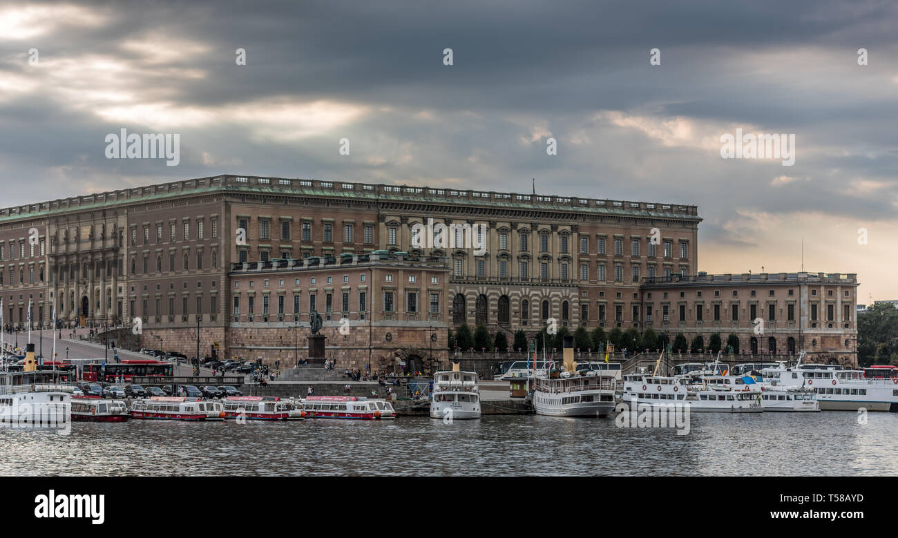 The Stockholm Palace, the official residence of the Royal Family, overlooking the ferries moored on the Stromkajen Stock Photo
