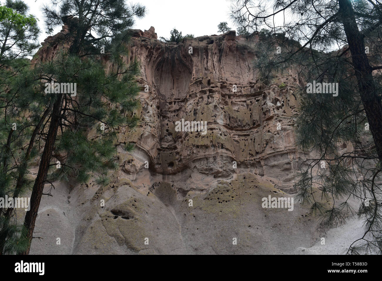 Interesting look at a cliff face with caverns and rooms cutout of the sandstone. Stock Photo